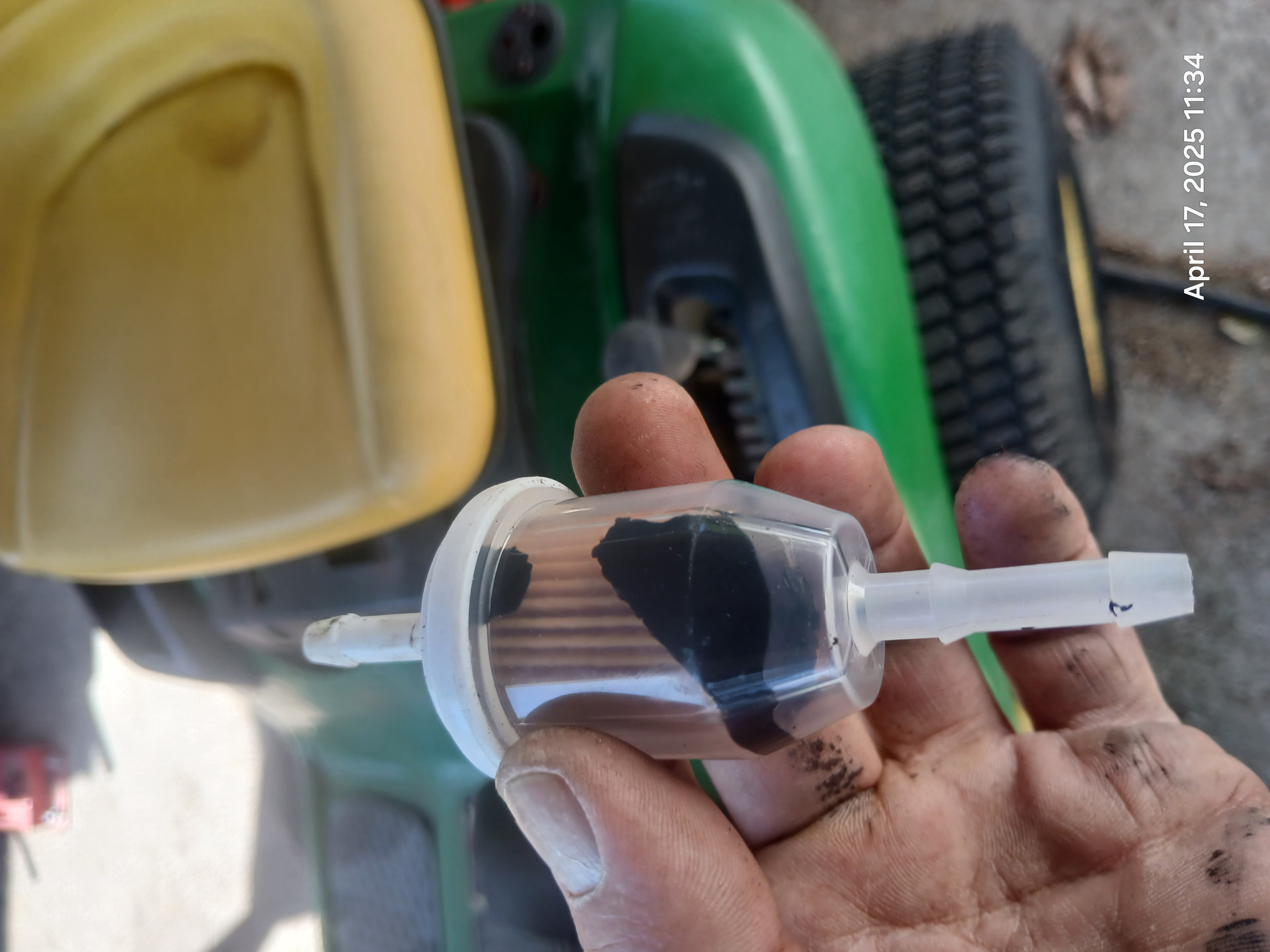 Fuel filter completely clogged with black sludge from ethanol-degraded rubber fuel line on a John Deere riding mower